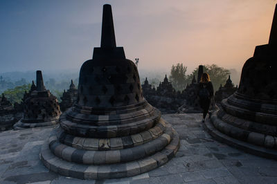 Close-up view of ancient temple against cloudy sky