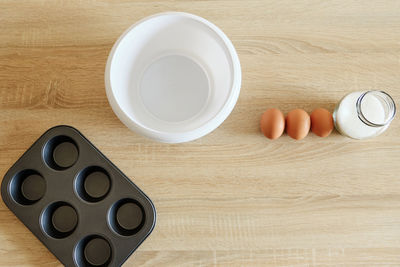 Cookware with baking ingredients plates and shapes waiting to cooked