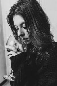 Portrait of a beautiful young woman drinking glass