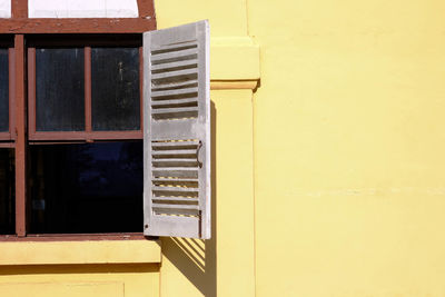 Close-up of yellow window on building