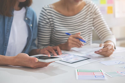 Midsection of businesswomen working at desk in office