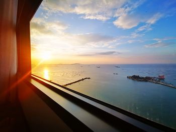 Scenic view of sea against sky seen through glass window