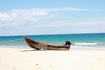 Boat on beach against sky