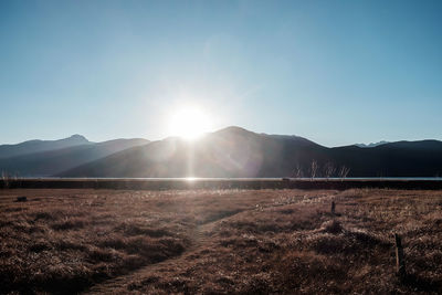 Scenic view of mountains against bright sun