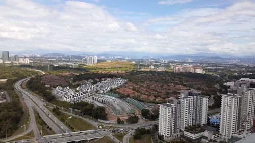 High angle view of city buildings against sky