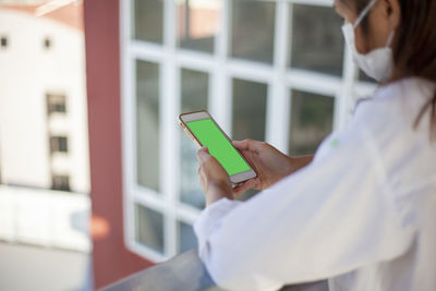 Midsection of woman using mobile phone