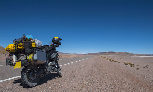 Touring motorbike on side of a highway in the atacama desert / chile