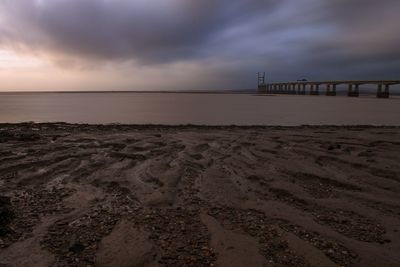 Scenic view of beach against sky during sunset