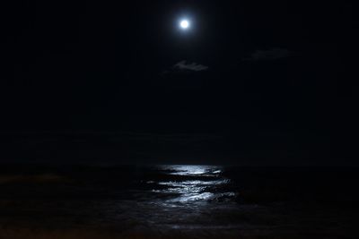 Scenic view of sea against moon at night