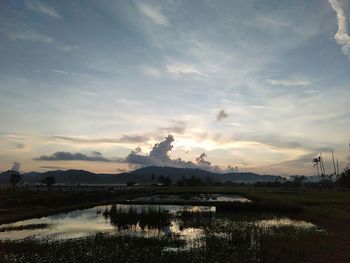 Scenic view of lake against sky during sunset