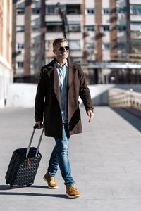 Full length of young man walking in city