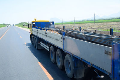 Vehicles on road against sky