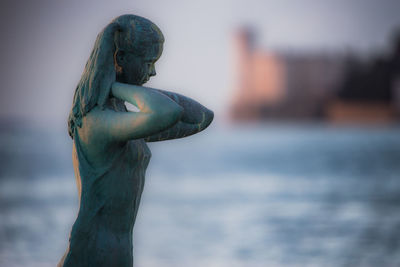 Close-up of statue against sea