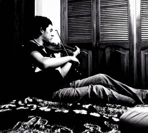 Boy sitting on bed at home