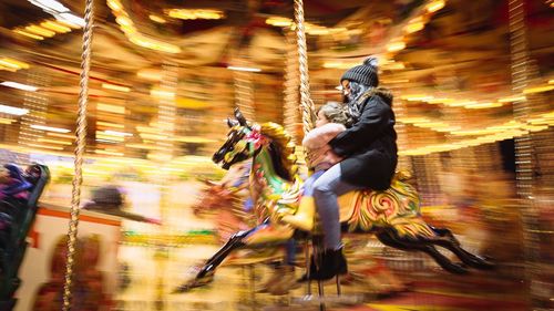 Blurred motion of person riding horses