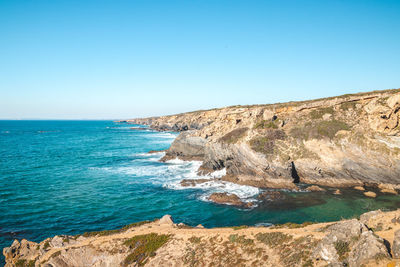 Scenic view of sea against clear blue sky