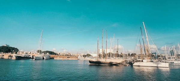 Sailboats in city against sky