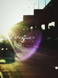 Traffic on road at sunset