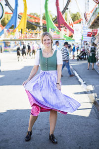 Portrait of woman standing on street at event