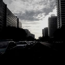 Buildings against cloudy sky