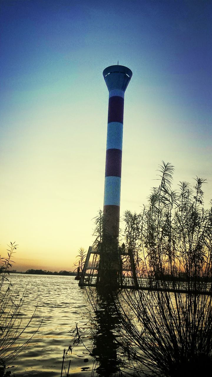 water, sea, clear sky, tranquility, sunset, blue, tranquil scene, nature, protection, horizon over water, scenics, beauty in nature, safety, copy space, guidance, lighthouse, sky, built structure, security, no people