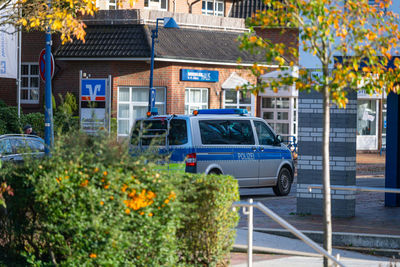 Cars on road by residential buildings