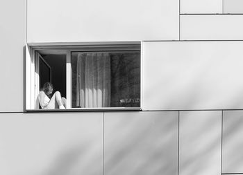 Woman looking through window