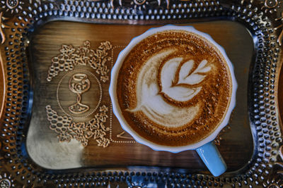 High angle view of cappuccino served on table