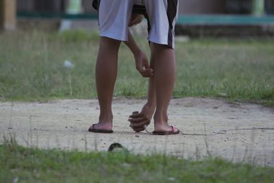 Rear view of boy playing on field
