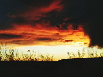 Scenic view of dramatic sky at sunset