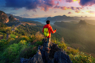 Side view of man standing on mountain