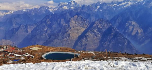 Panoramic view of snowcapped mountains in the background of an artificial lake at a skea resort