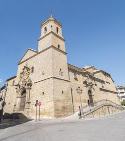 Low angle view of historic building against clear blue sky