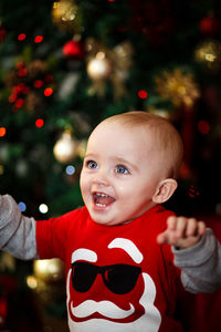 Portrait of cute baby girl on christmas tree