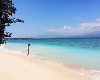 Scenic view of beach against blue sky