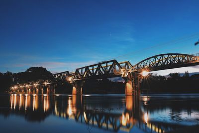 Bridge over river against sky during dusk