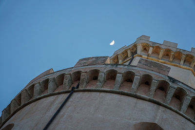 Low angle view of historical building against clear blue sky