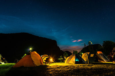 Tent on field against sky at night