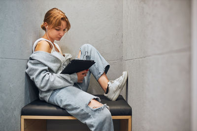 Student learning in library. young woman reading e-book using computer tablet. using technology