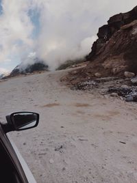 Scenic view of mountains against cloudy sky