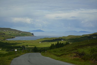 Scenic view of sea and mountains against sky