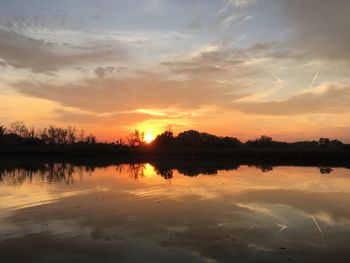 Scenic view of lake against sky during sunset