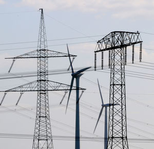 Low angle view of electricity pylon against sky