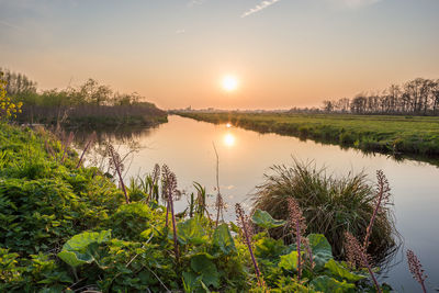 Scenic view of lake against sky during sunset