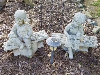 High angle view of statues on field