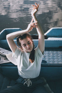 Beautiful young woman sitting boat