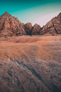 Scenic view of arid landscape against sky