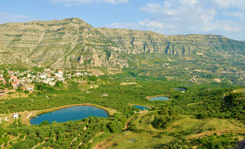 Scenic view of lake and mountains against sky