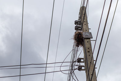 Low angle view of communications tower against sky