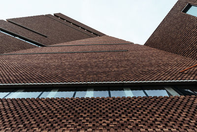 Low angle view of roof and building against sky